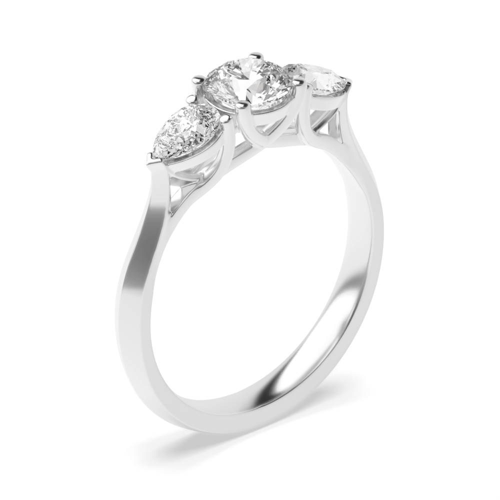 4 prong setting round and pear trilogy diamond engagement ring